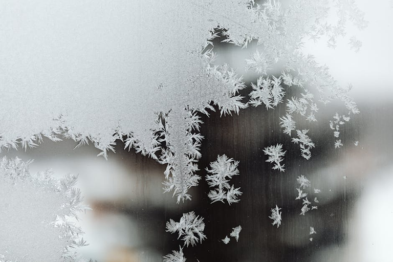 Frosted single pane window in winter showing heat loss - perfect for bubble wrap insulation
