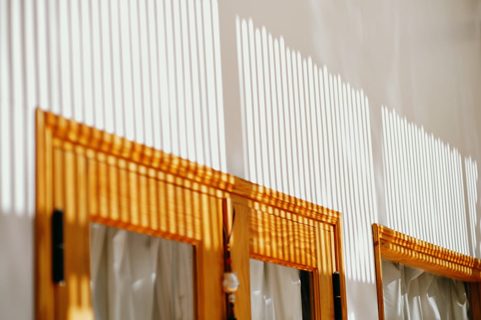 Intense summer sunlight streaming through window blinds creating heat in a room - bubble wrap can help block this