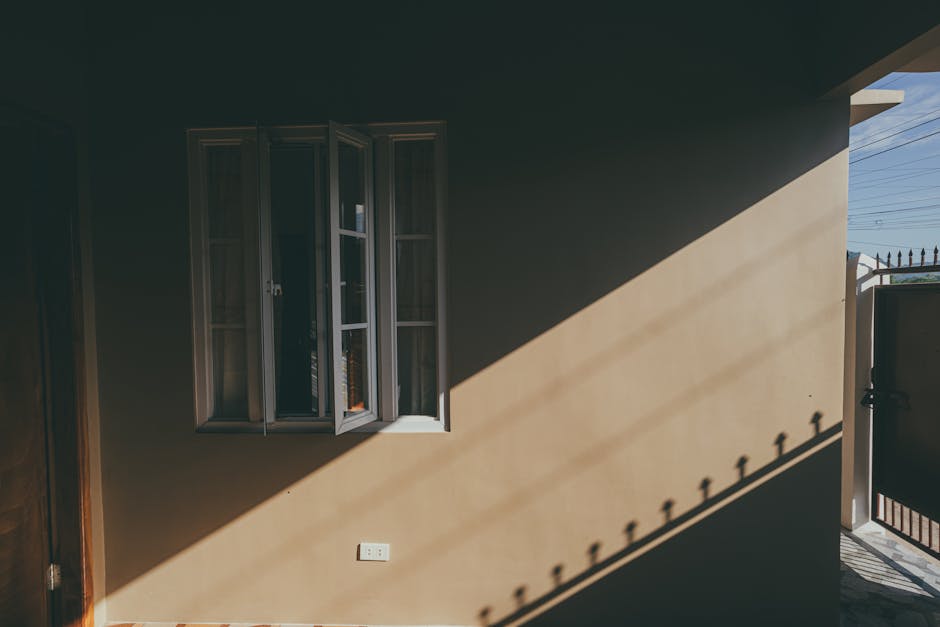 Warm sunlight streaming through a south-facing window into a room — passive solar heating uses this free heat directly without any equipment or running costs