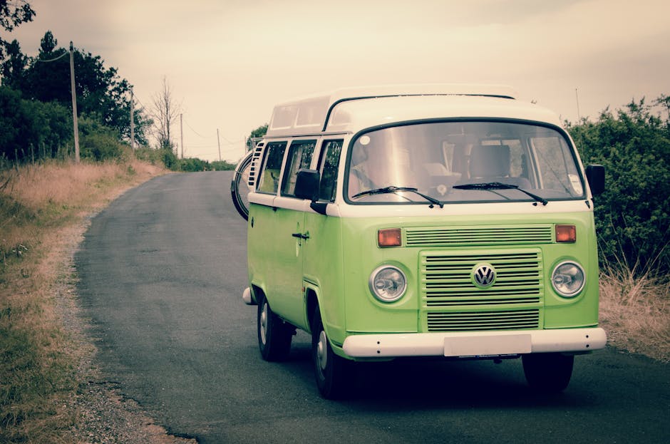 Classic VW campervan on a country road — a rooftop solar panel provides all the electricity a campervan needs for lighting, phone charging and a fridge with no hookup fees